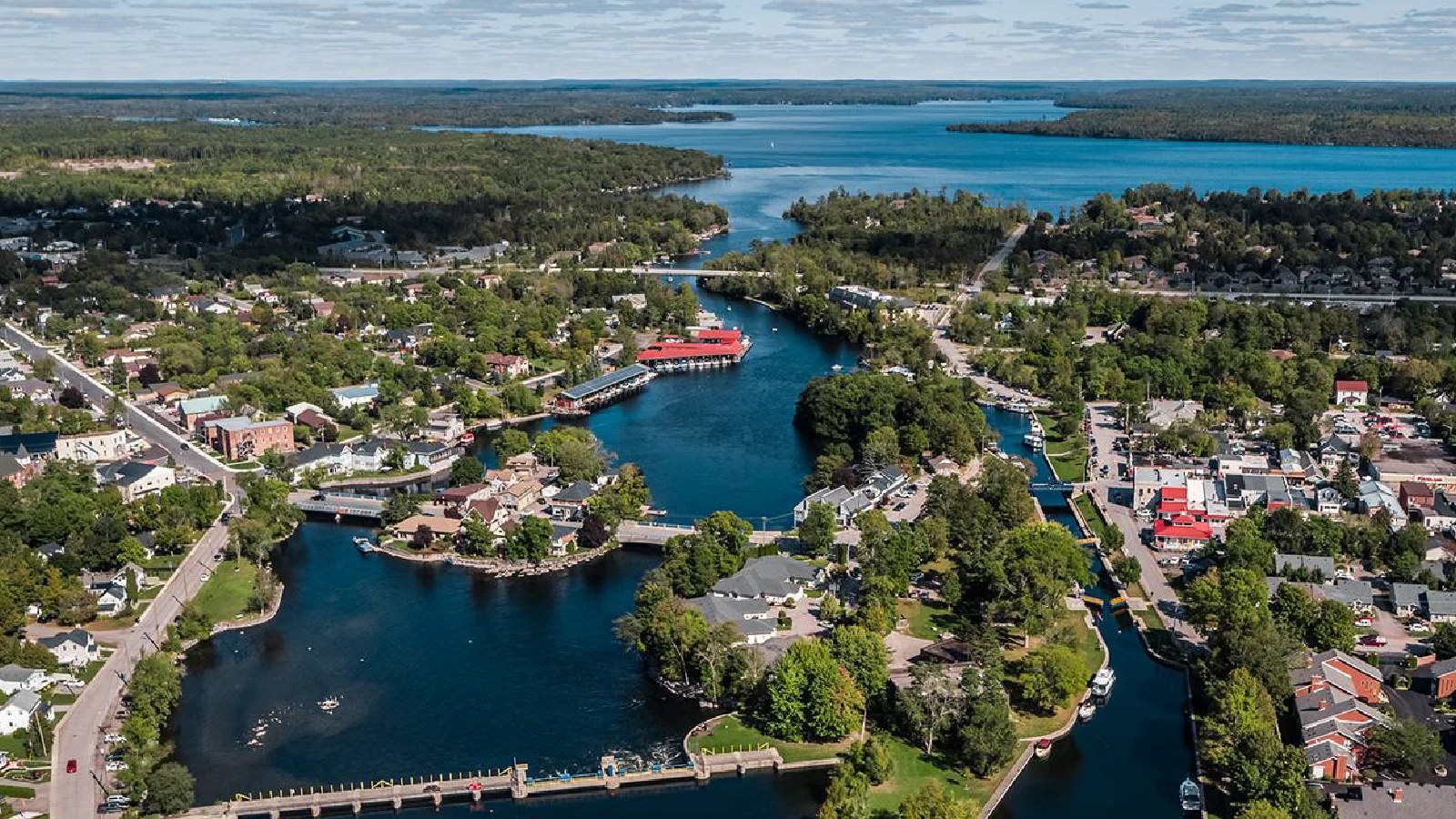 Aerial view of Bobcaygeon Lock 32 and the Trent-Severn Waterway with boats, bridges, and downtown waterfront in Kawartha Lakes Ontario