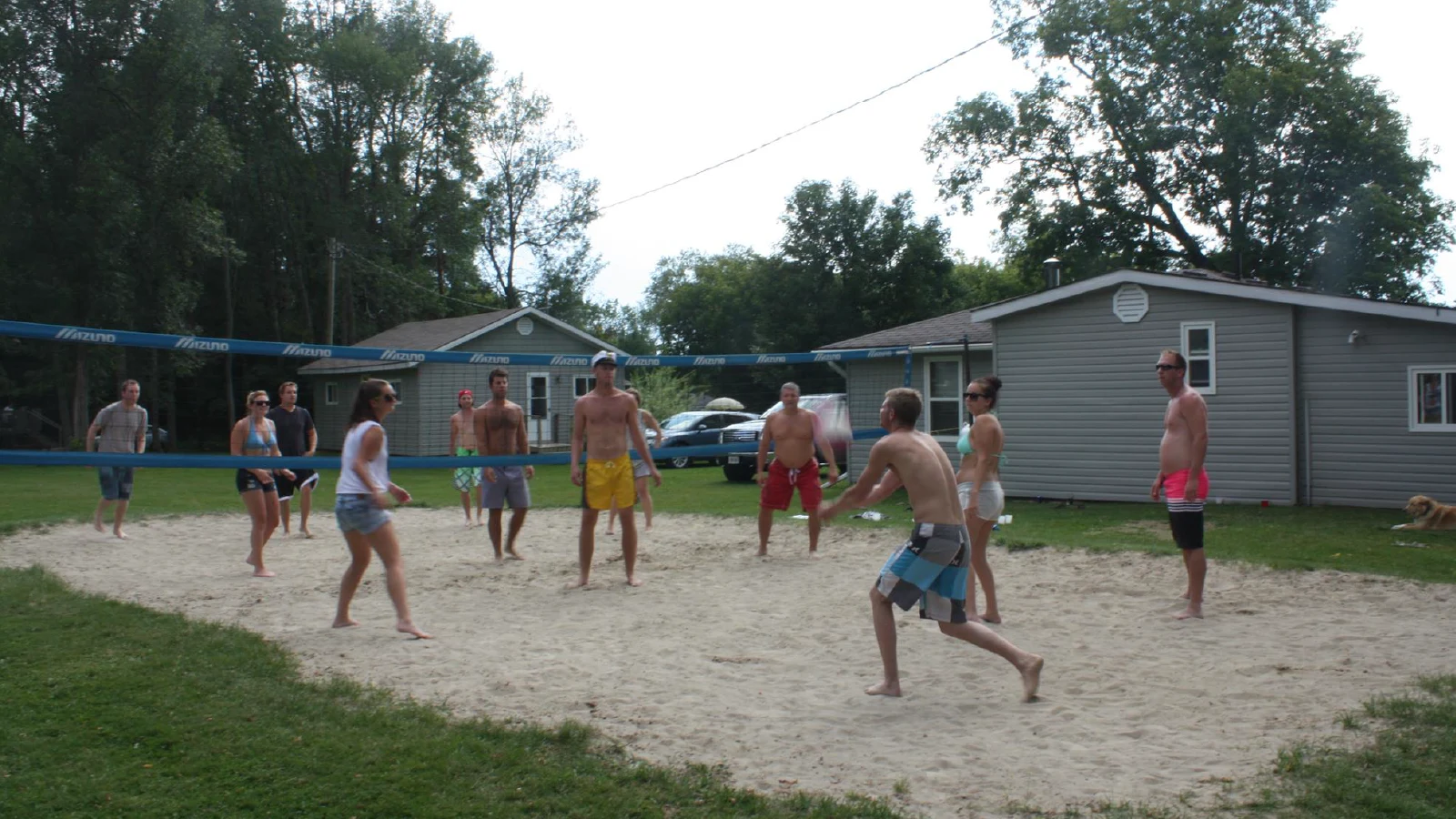 Guests playing beach volleyball and badminton at Pigeon Lake cottages in Kawartha Lakes Ontario